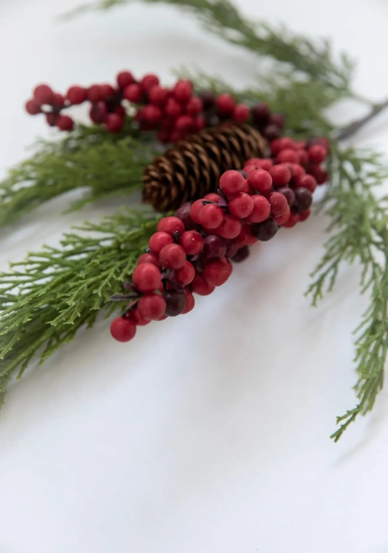 Artificial cedar and red berries branch