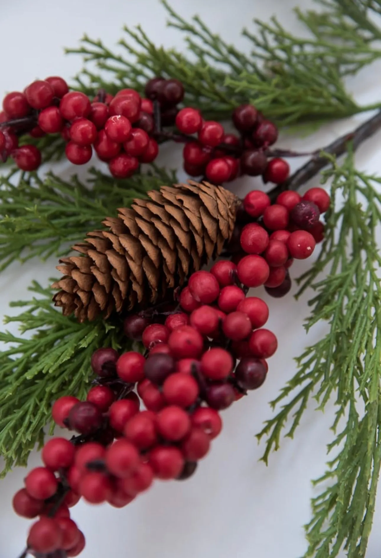 Artificial cedar and red berries branch