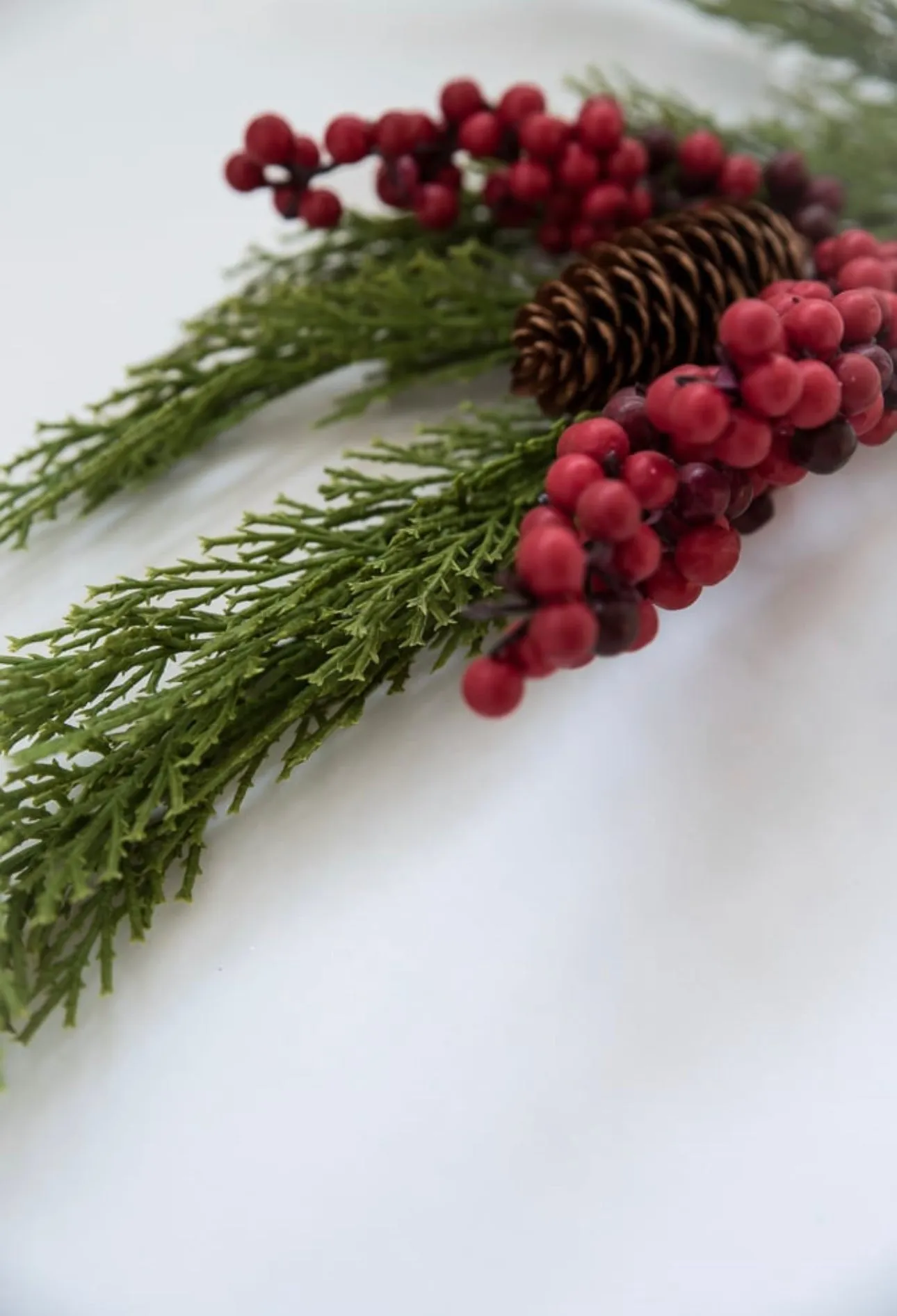 Artificial cedar and red berries branch